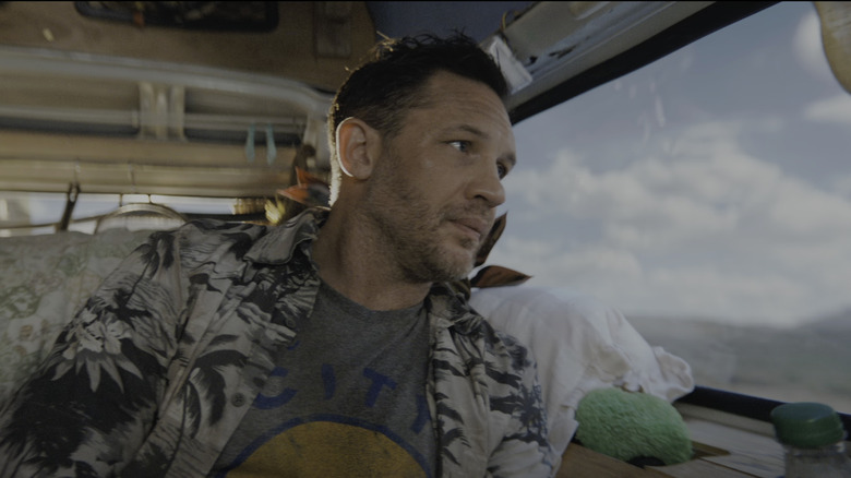 Tom Hardy's Eddie Brock looks out the window of a van in Venom The Last Dance