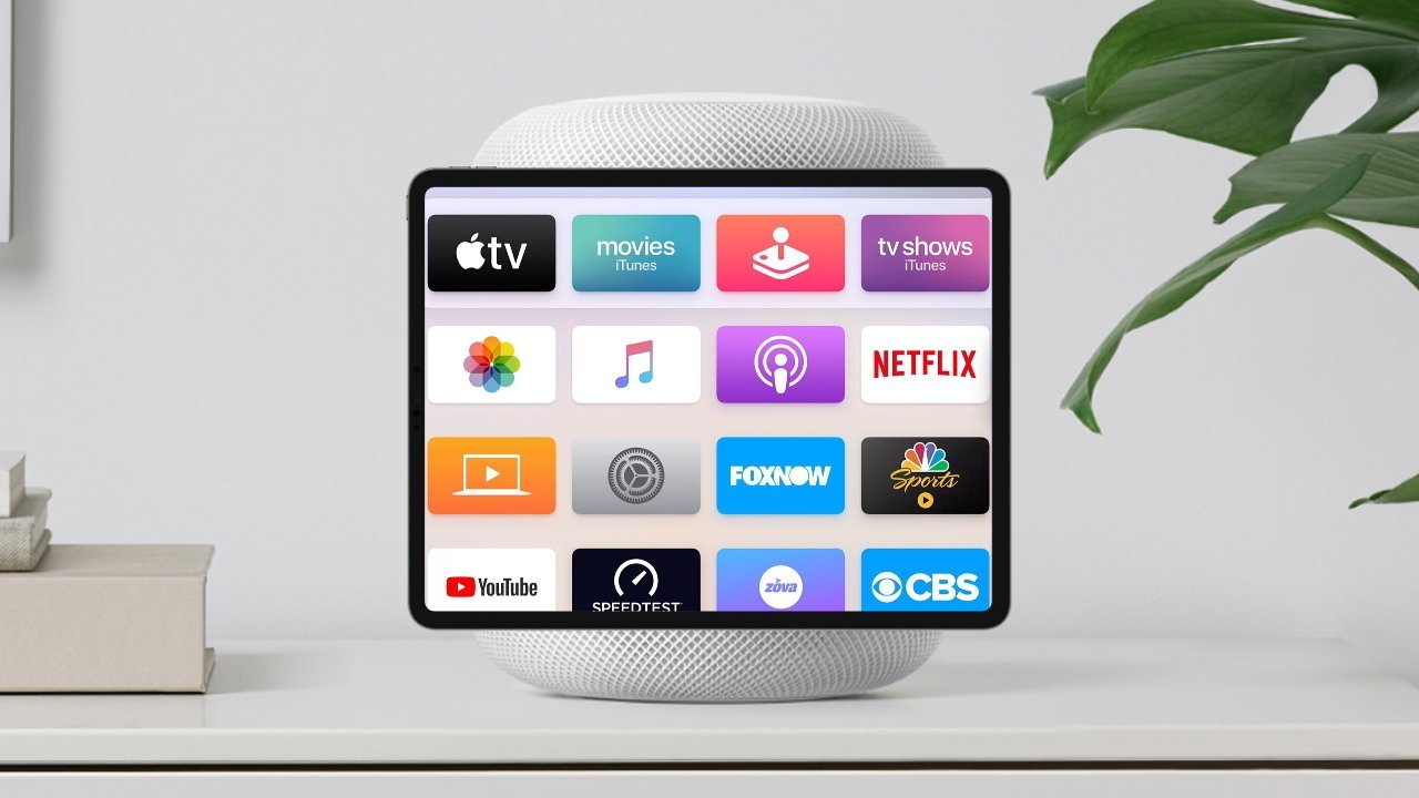 Tablet displaying various streaming apps sits atop a smart speaker on a white surface, beside plant and books.