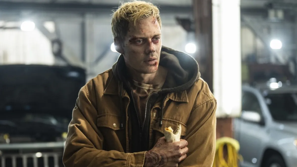 Bill Skarsgard as Eddie holding a burrito in Locked