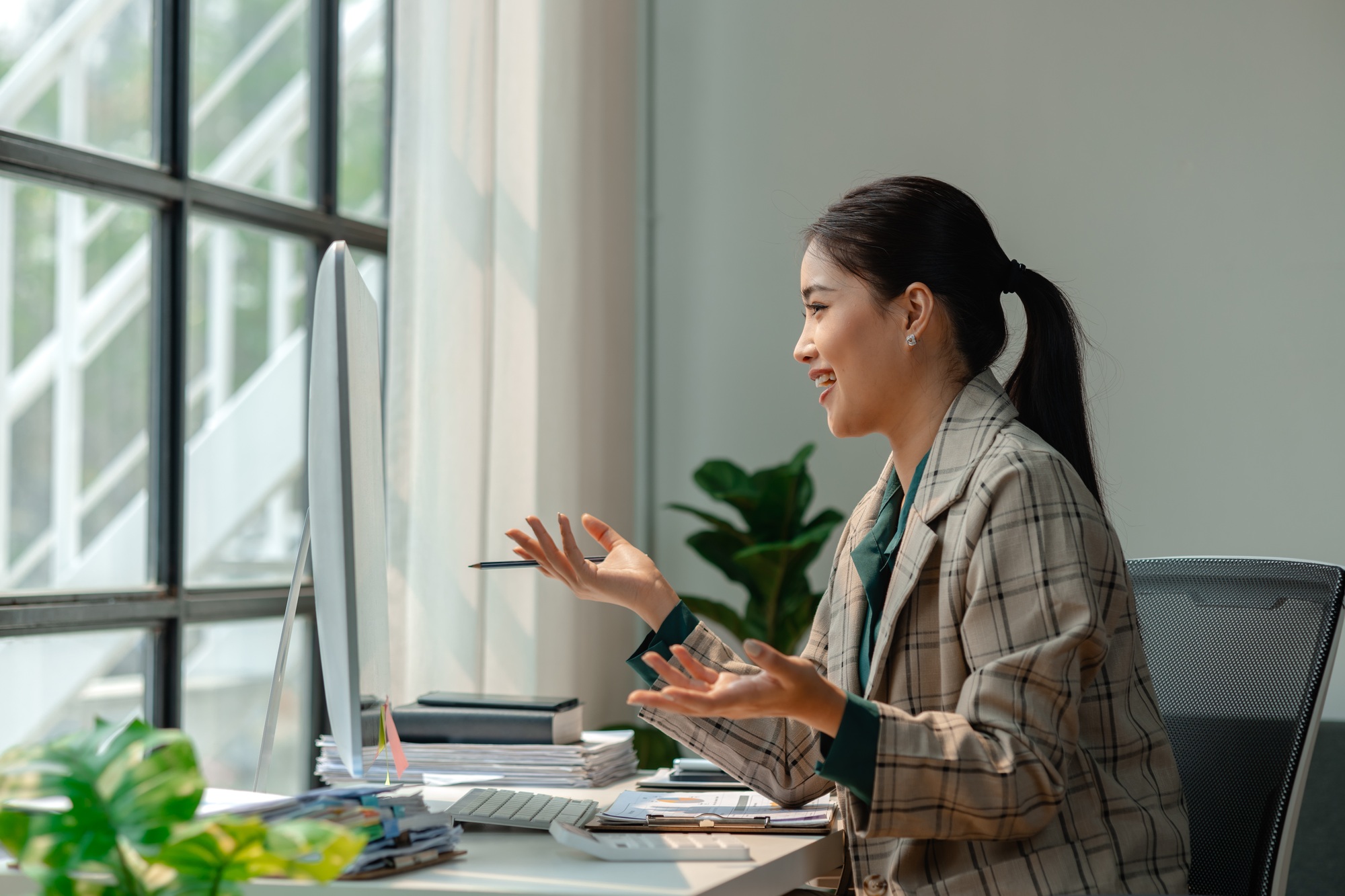 a businesswoman is attending video conference with her team to discussion about marketing strategy,