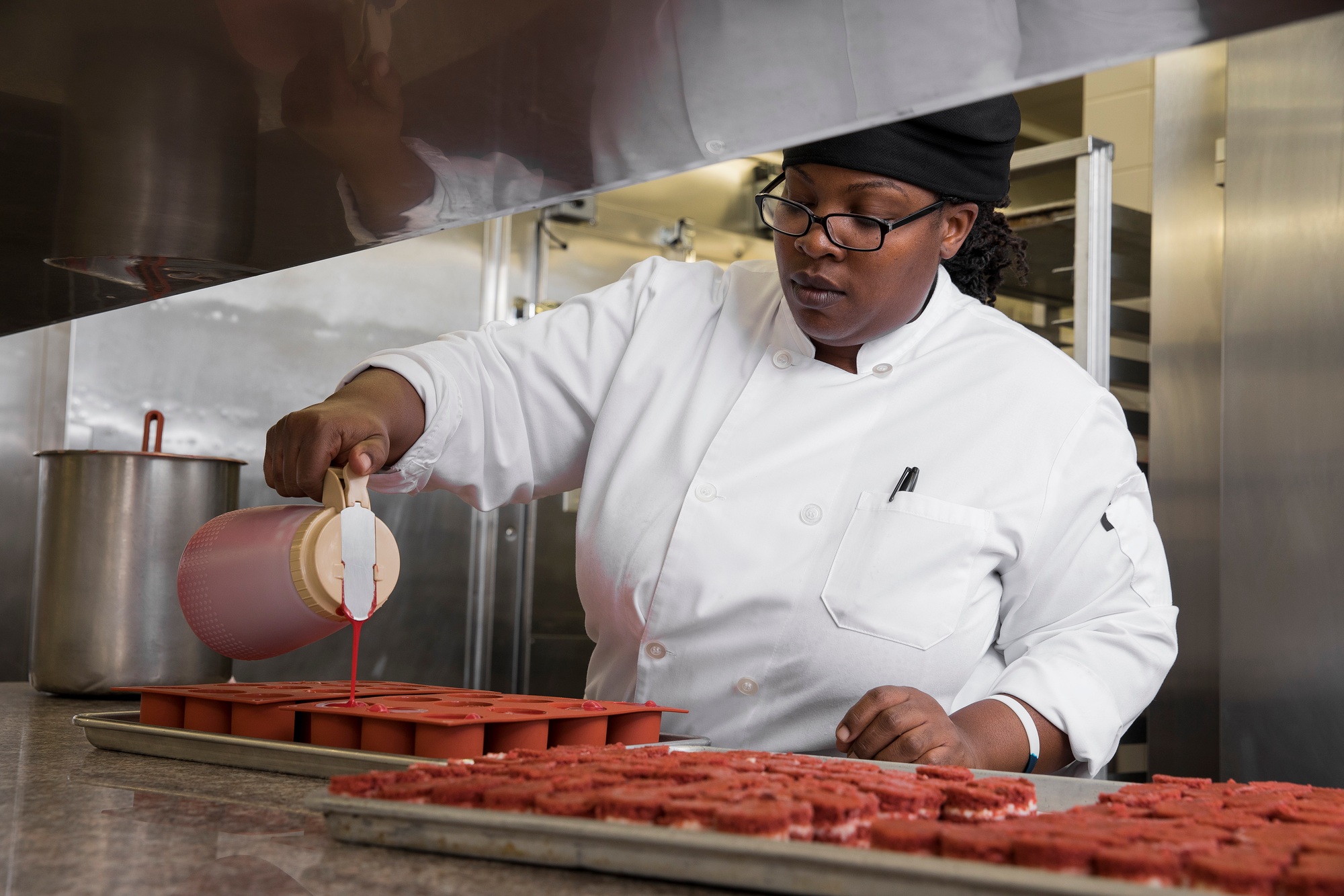 Chef in commercial kitchen preparing cakes
