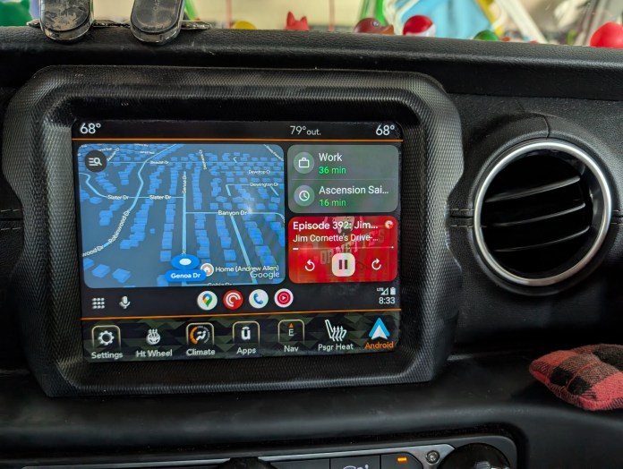 A car infotainment system display showing navigation, music controls, and various app options.