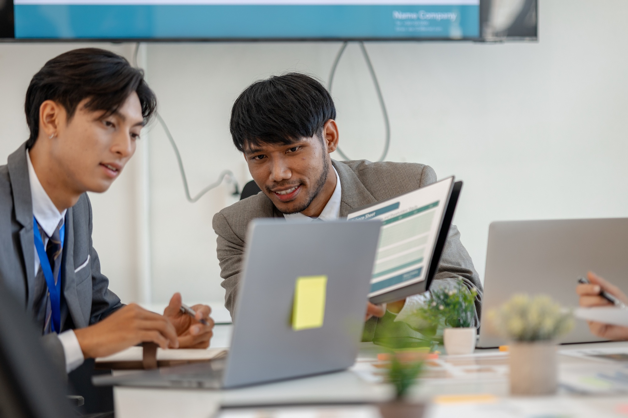 employees are discussing marketing strategies in a conference room
