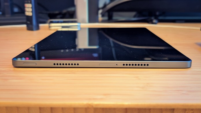 Side view of the Lenovo Idea Tab Pro tablet showing its sleek design, buttons, and speaker grill.