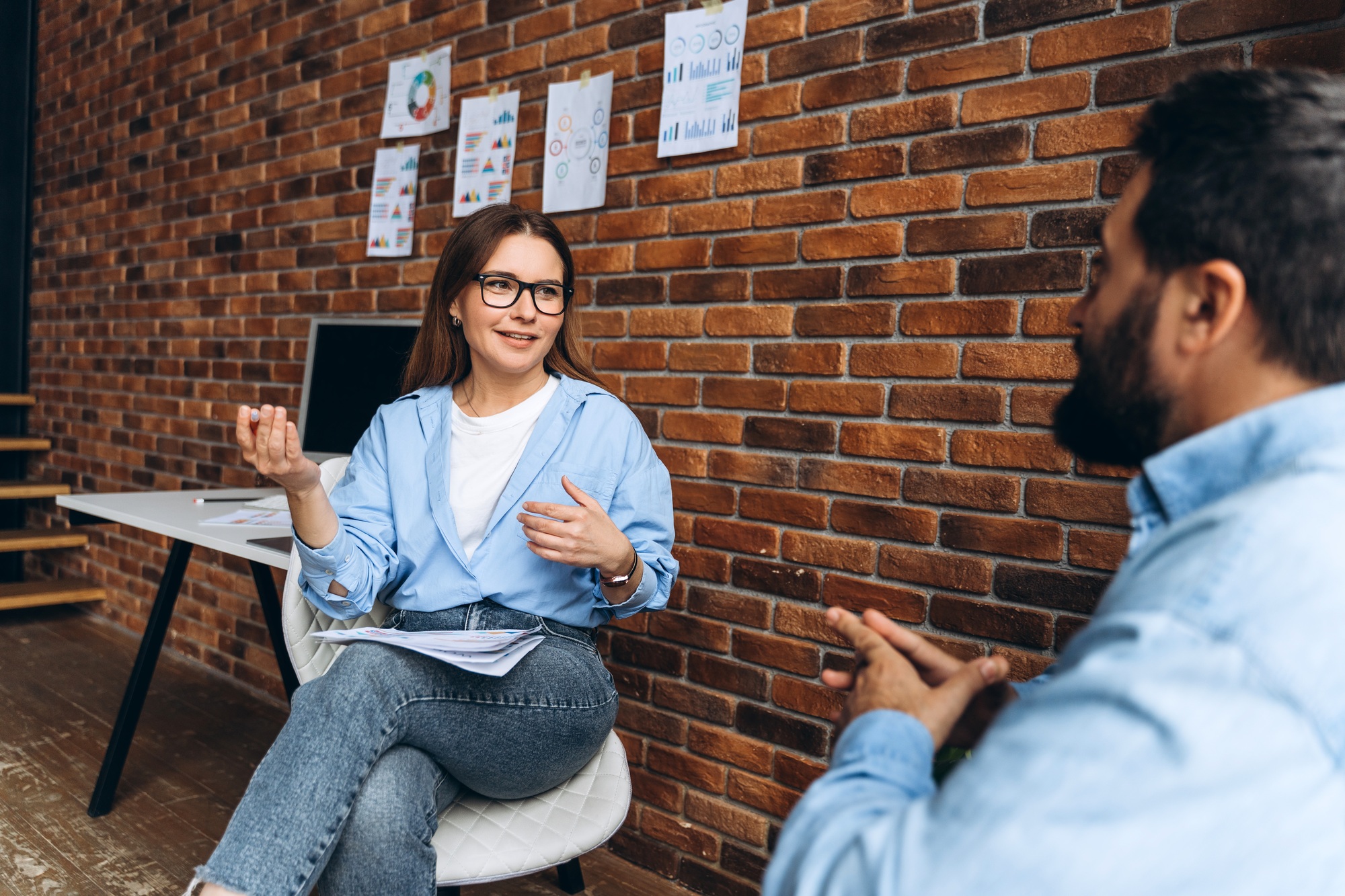 Businesswoman explaining marketing strategy to businessman in office