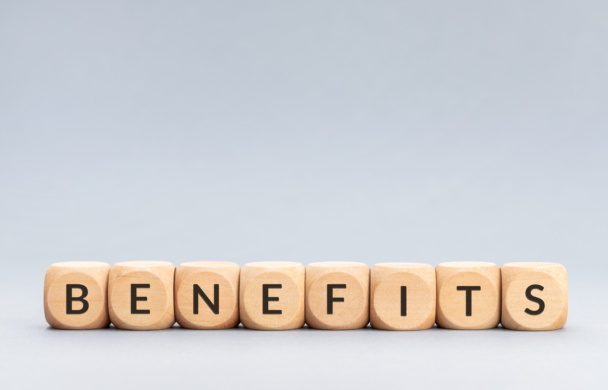Benefits word on wooden blocks on gray background