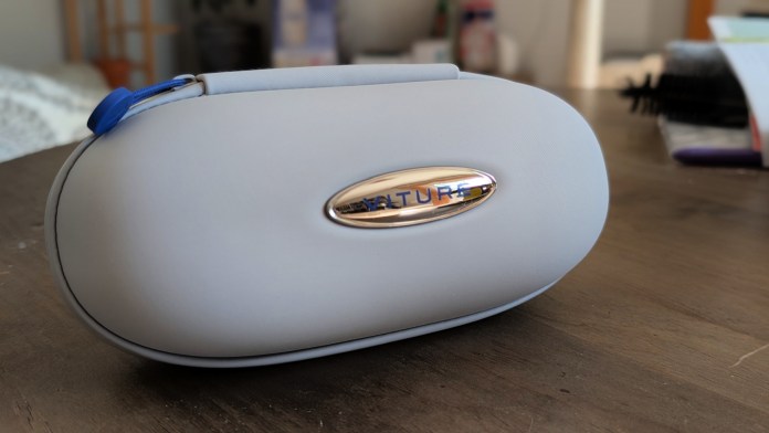 A close-up image of the VITURE Luma Pro carrying case, featuring a sleek gray exterior with a shiny silver VITURE logo, resting on a wooden table.