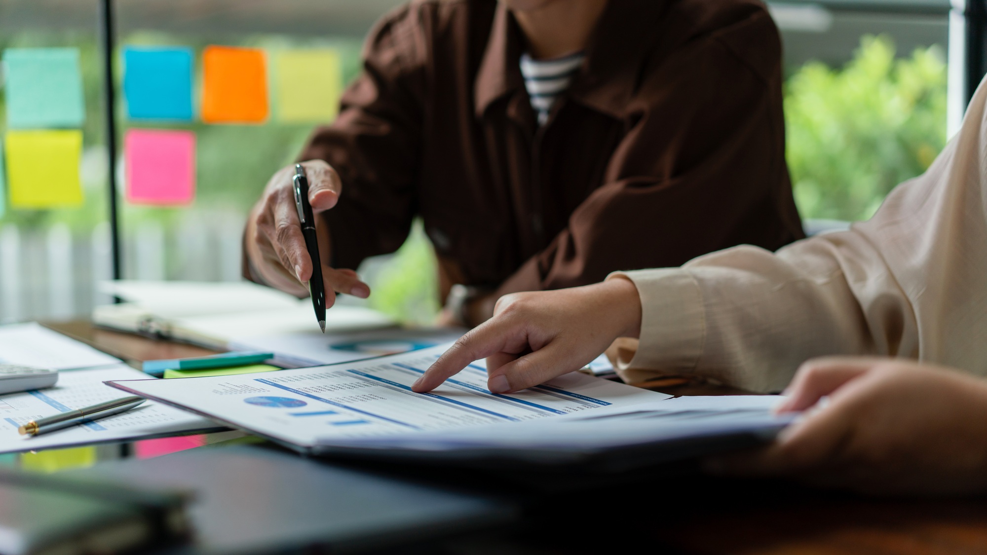 Business colleague reading financial budget document to brainstorming and analysis business project