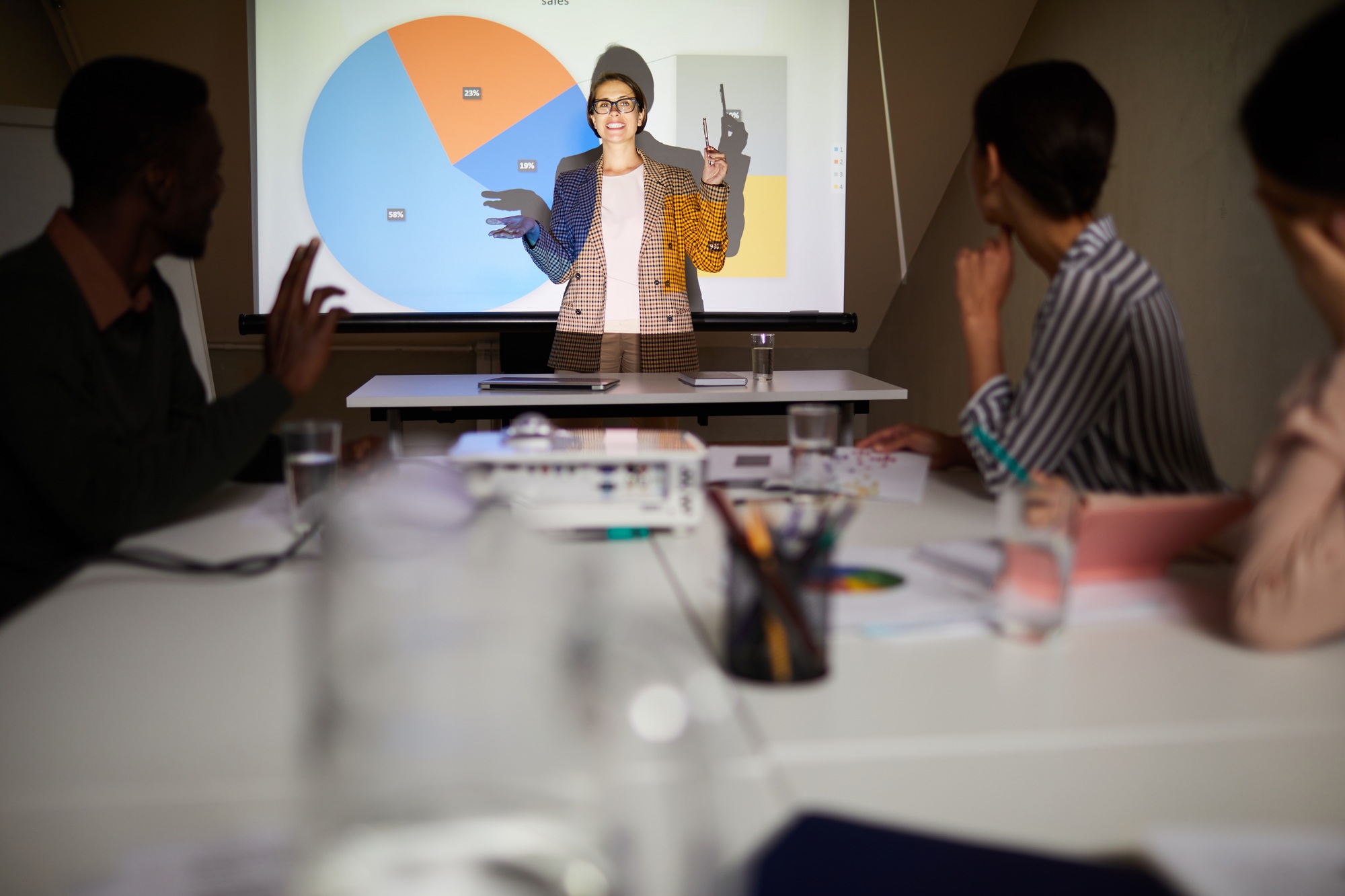 Financial analyst presenting charts at meeting