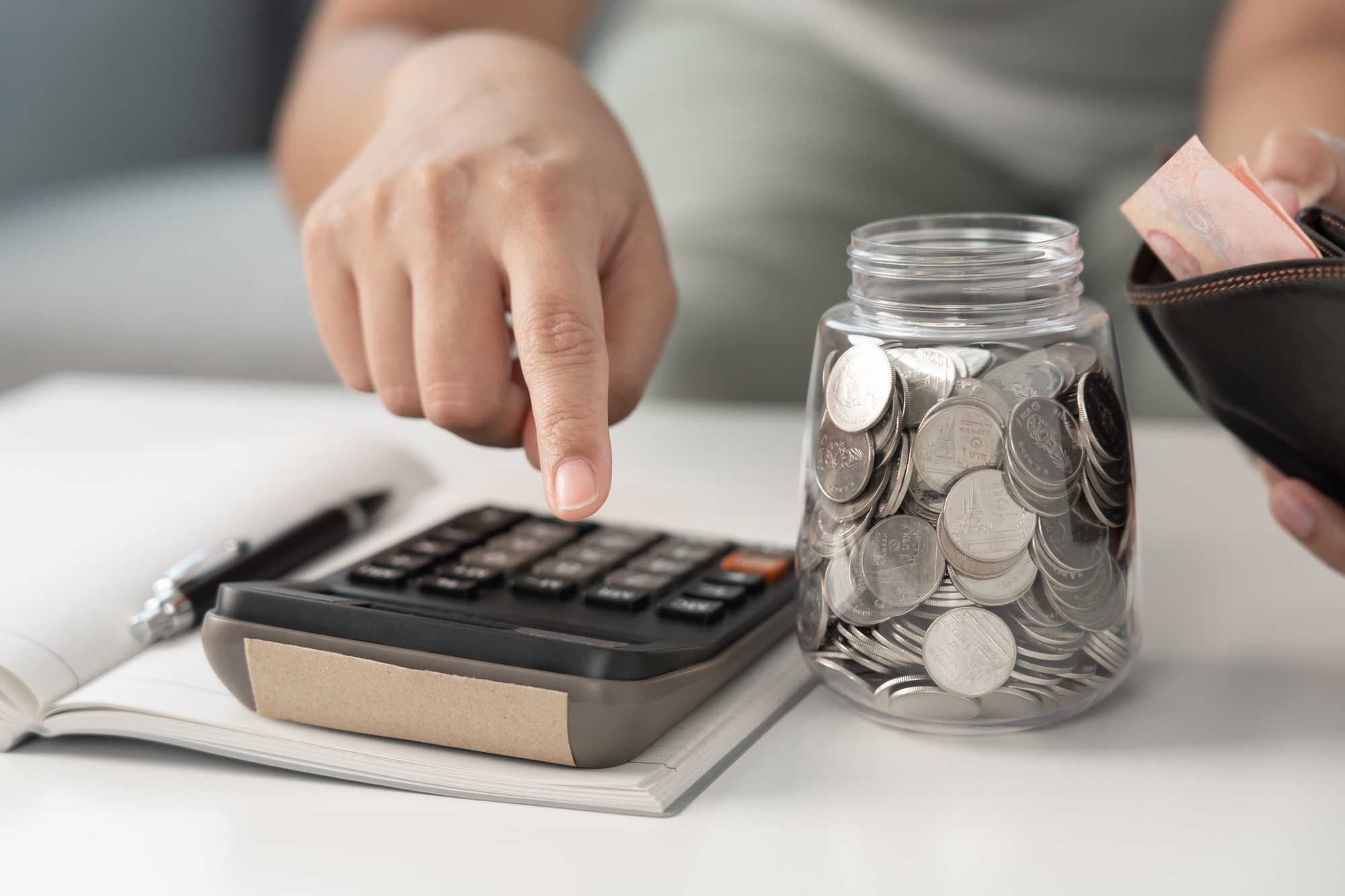 Woman calculating money coin for household saving