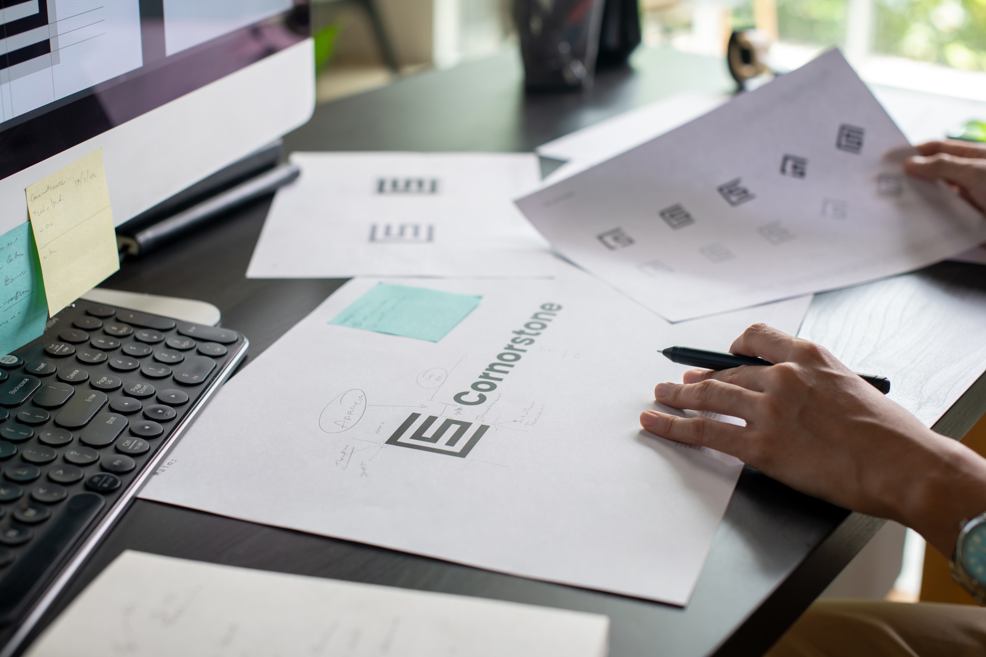 Graphic designer drawing sketches logo design.