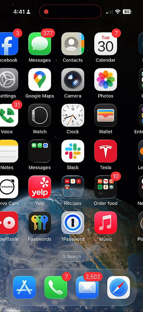 On an iPhone homescreen, the search bar and carousel dots transform into each other as the user scrolls. 