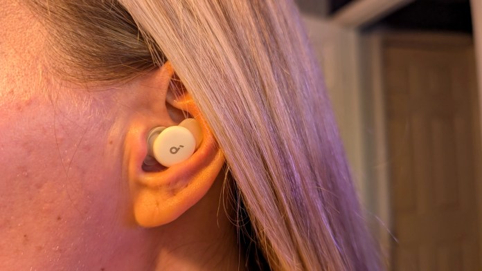 Close-up of an ear with a sleep earbud inserted, showcasing its slim design and fit.