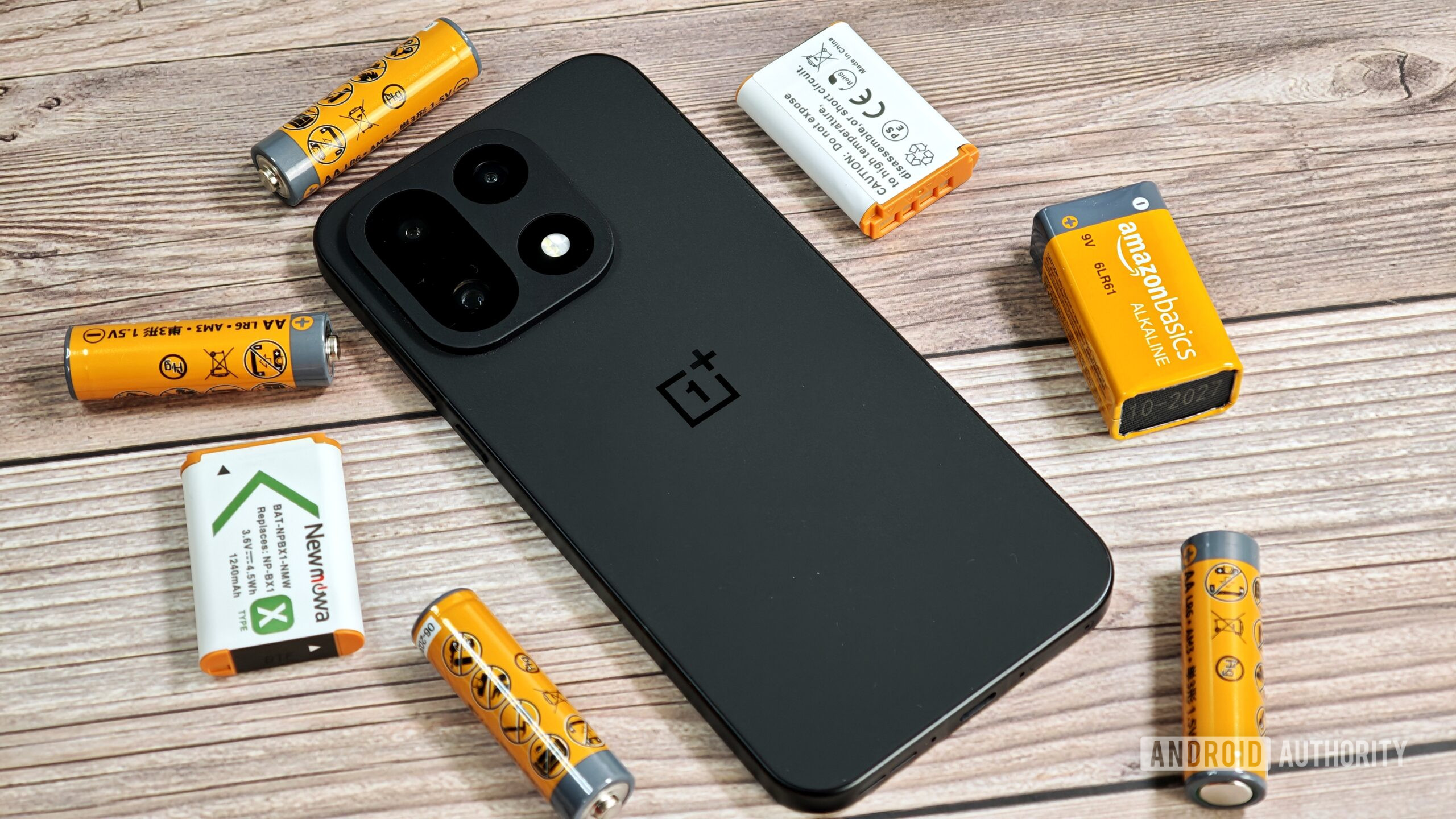OnePlus 15 surrounded by batteries OnePlus 15 surrounded by batteries
