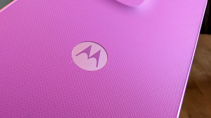 Close-up of a textured purple surface featuring a circular Motorola logo.